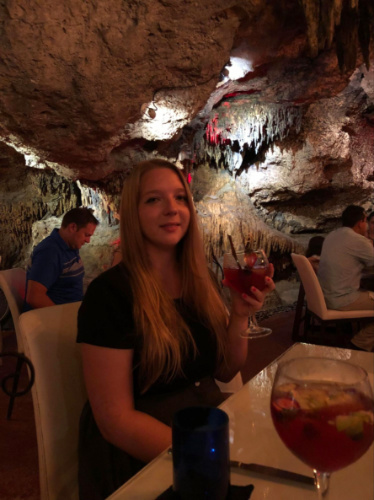 The author Taylor holding a drink at Alux