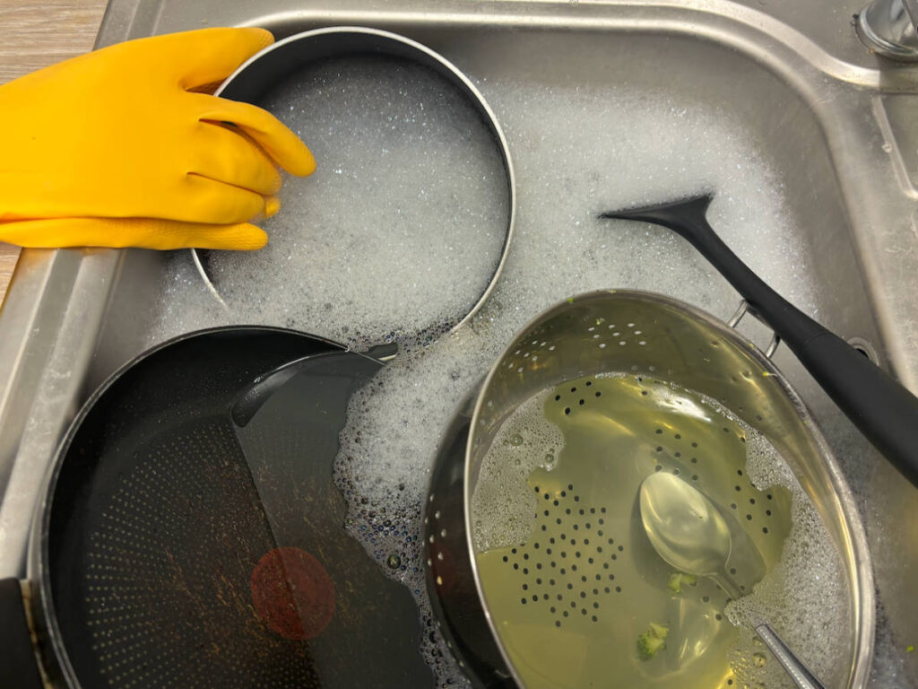 Dishes soaked in soapy water before washing