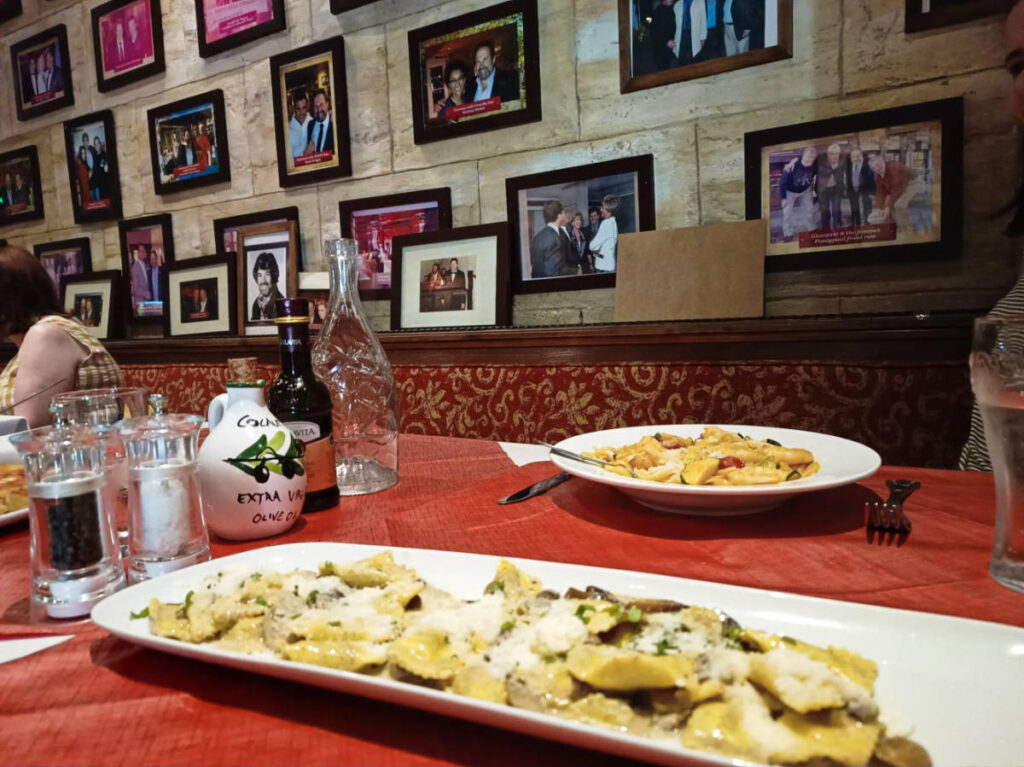 View of the dishes and the interior with picture frames on the wall at Giovanni’s Restaurant