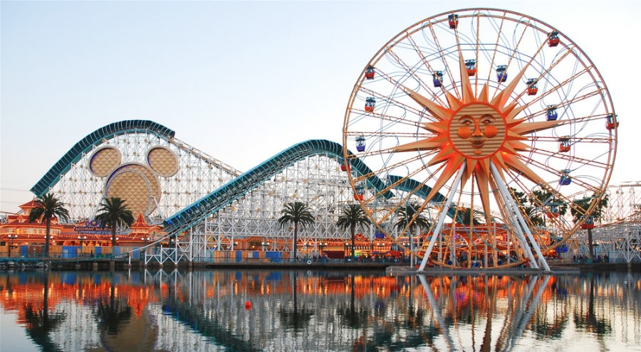 An image of Ferris Wheel, roller coaster and other rides at Paradise Pier.