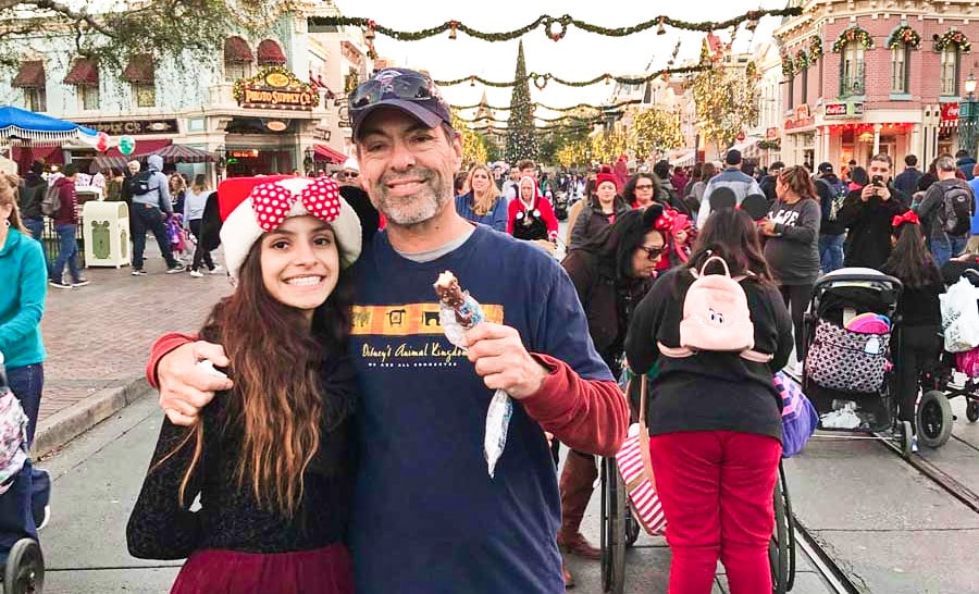 The author McKenna Mobley with her father and crowds at the Main Street during the holiday season