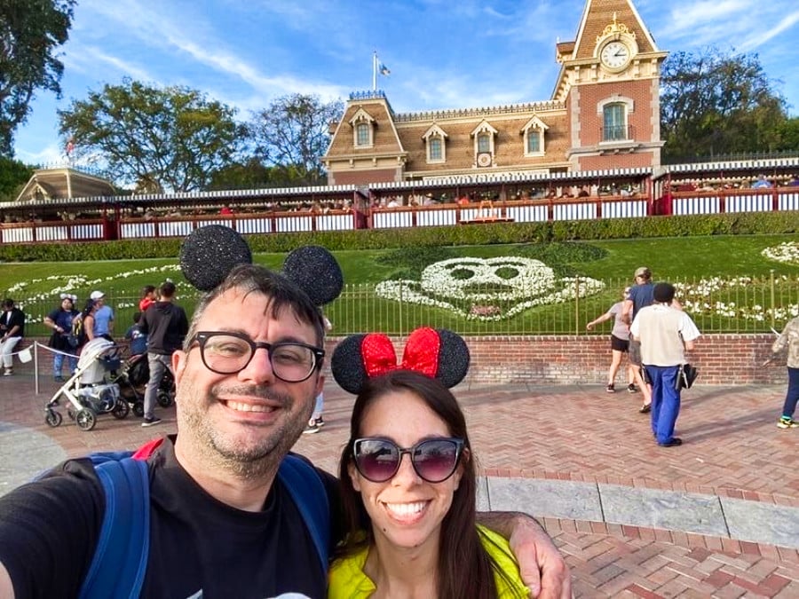 The author McKenna Mobley and a man taking a picture by themselves at the busy Disneyland entrance