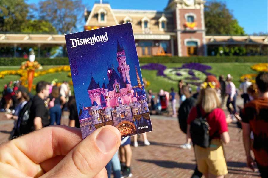 A hand holding a Disneyland card