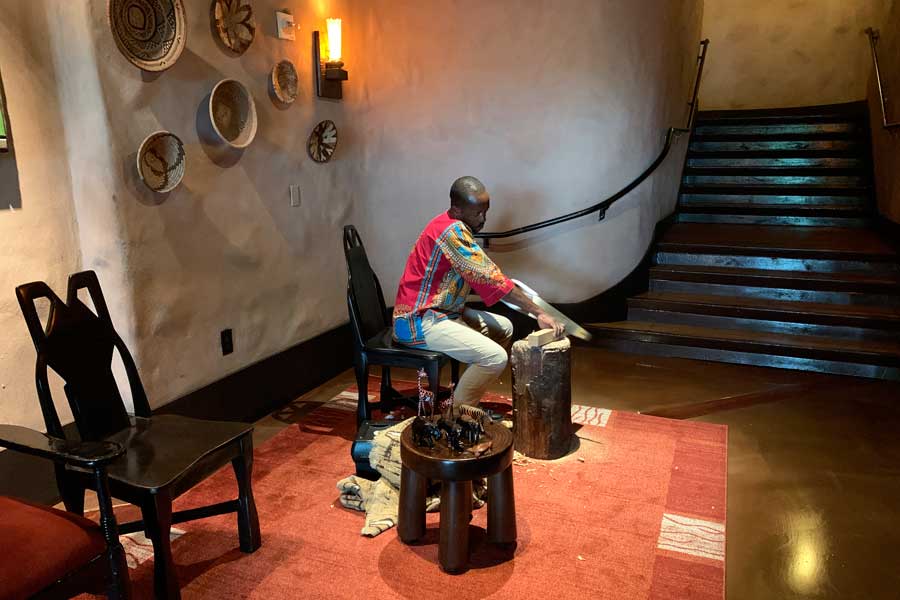 A man doing a wood work inside Disney's Animal Kingdom Lodge