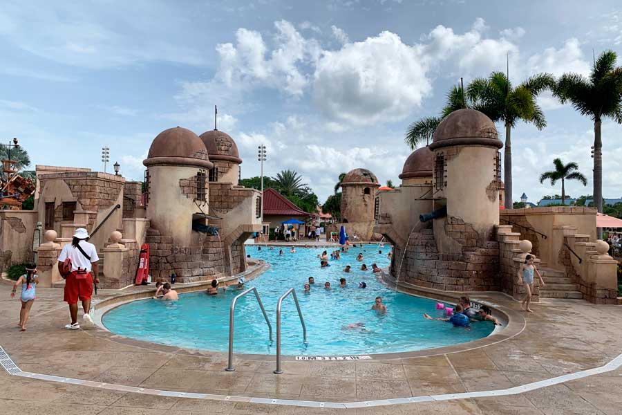 People enjoying their day in a pool in Disney’s Caribbean Beach Resort