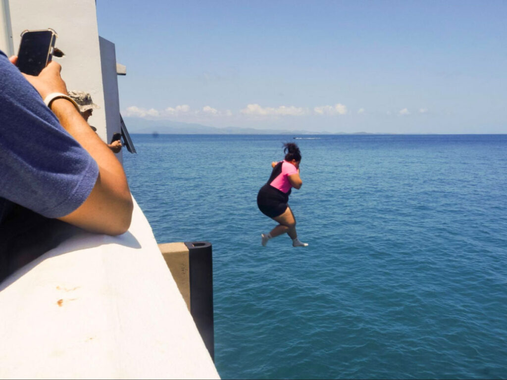 A woman diving from Mosquito Pier