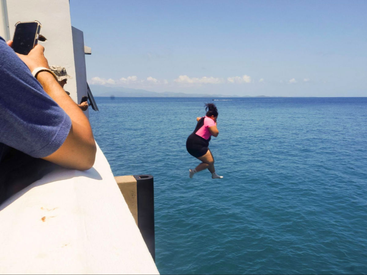A woman diving from Mosquito Pier