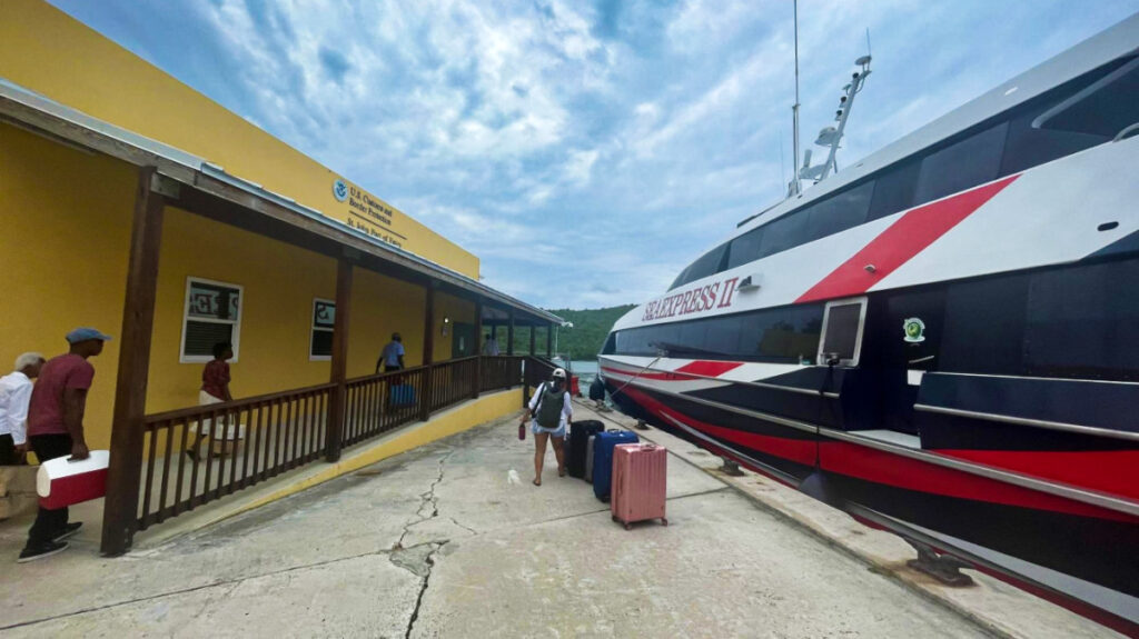 Travelers outside the docked ferry