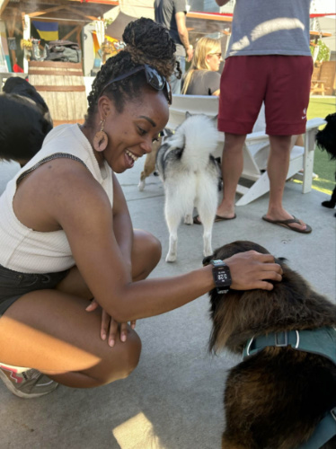 Author Chelsea petting a dog at Dog Yard Bar in Ballard