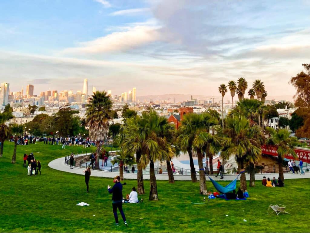 View of the people at the Dolores Park enjoying the San Francisco skyline