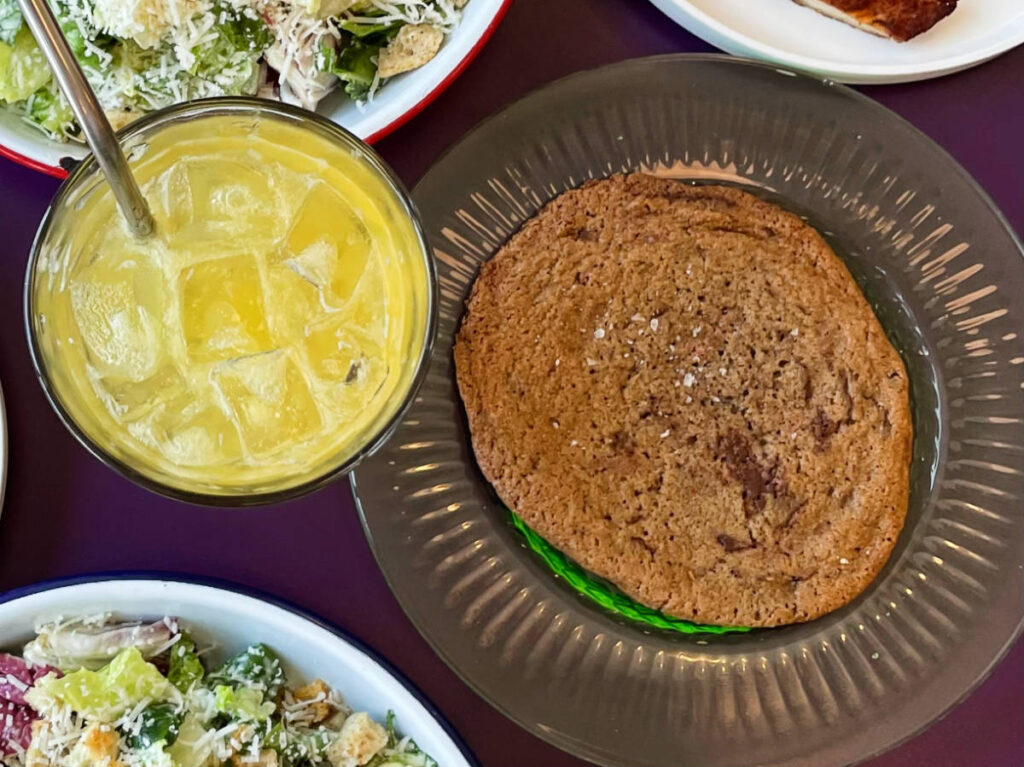 A cookie and a glass of juice from Doma Cafe