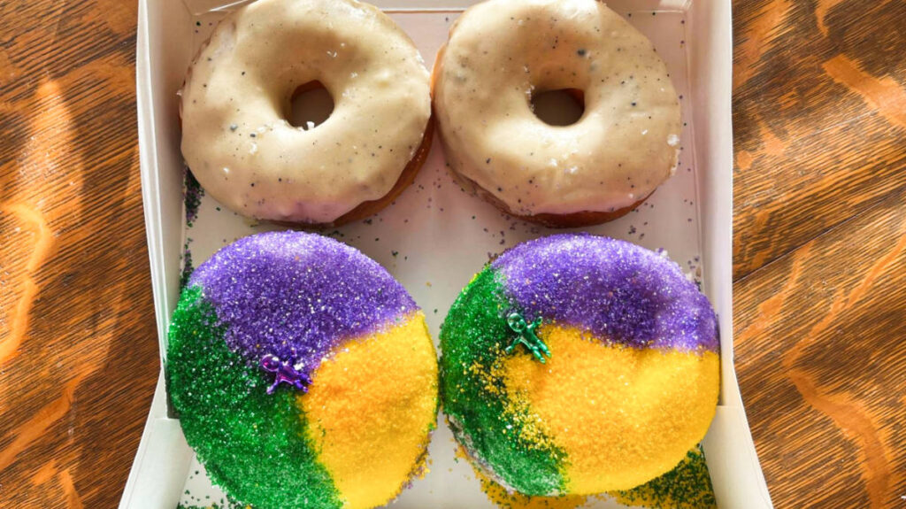 Closeup view of the salted brown butter donuts and seasonal king cake donuts from East Park Donuts 