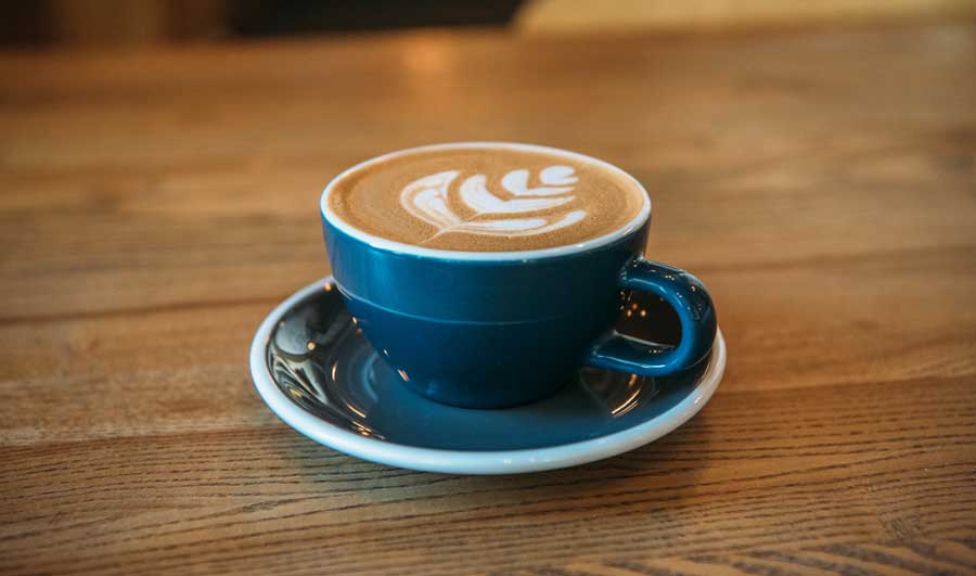 A cup of cappuccino on a table in Dose