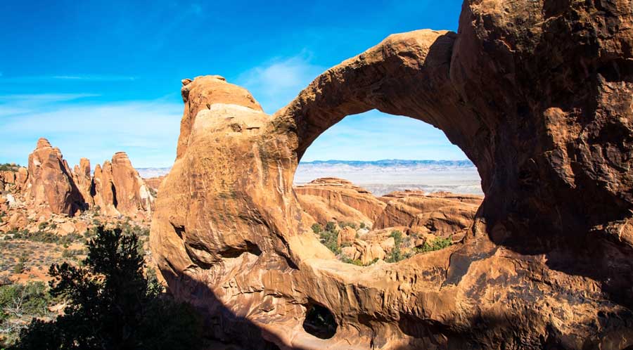 The Double O Arch Trail under the clear blue sky
