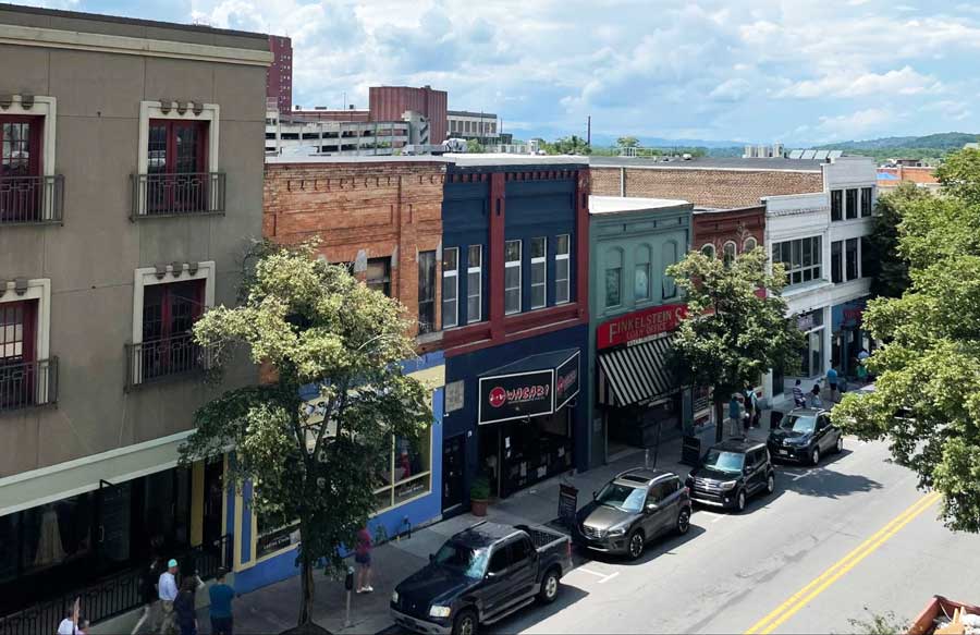 View of stores and cars parked alongside the road in Downtown Asheville
