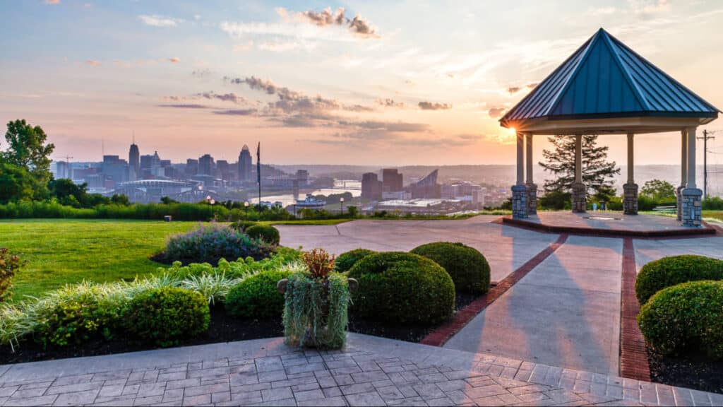 View of the downtown Cincinnati skyline and pavilion in Devou Park at sunrise