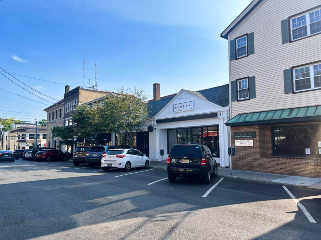 View of the vehicles parked outside the shops and restaurants in the Downtown Main Street of Pleasantville