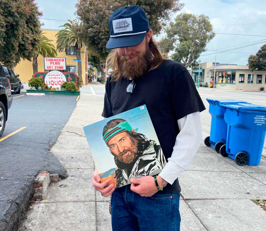 A man holding a record from a record store in Downtown Morro Bay