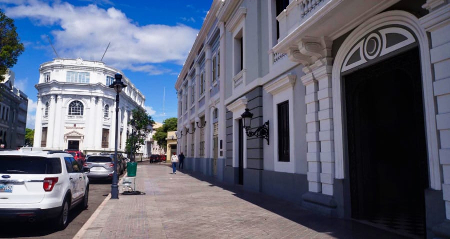 View of downtown Ponce with parked cars on the street.