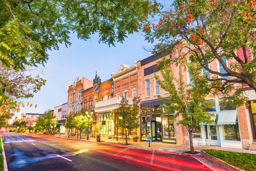 View of the illuminated shops at Center Street in downtown Provo at dusk