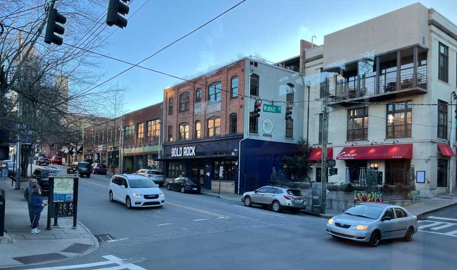 View of cars at an intersection on a street in Downtown Asheville