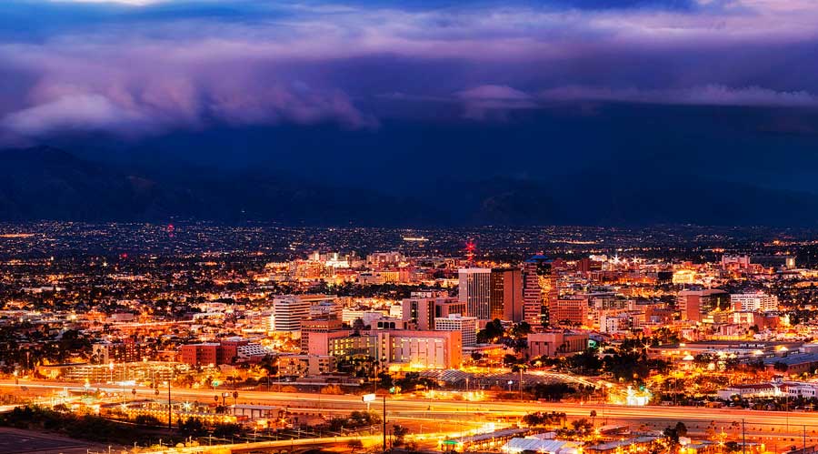 Aerial view of buildings with lights at night in Downtown Tucson