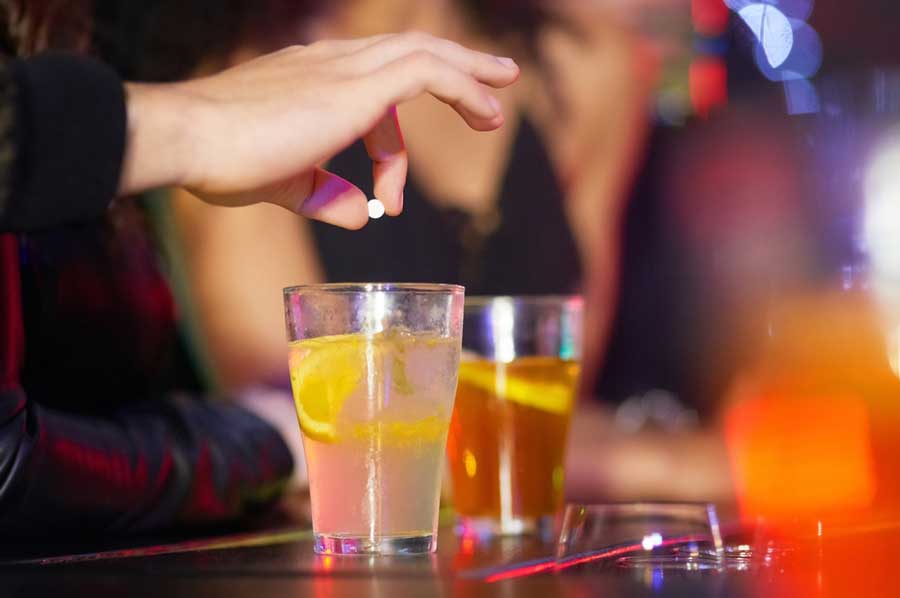 A man putting something on a drink