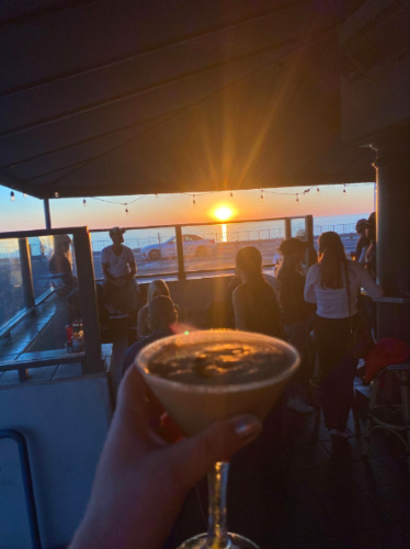 Holding an espresso martinis while the sun is setting