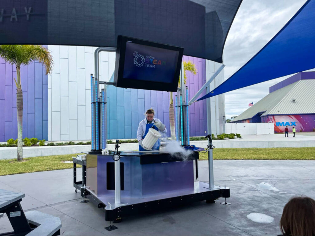 A man performing a dry ice experiment and presentation for kids