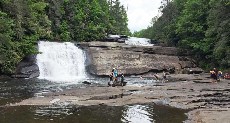 People enjoying their day at the Triple Falls in DuPont State Park