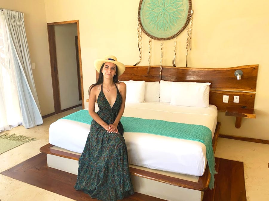 Clara sitting on a bed in Dune Boutique Hotel