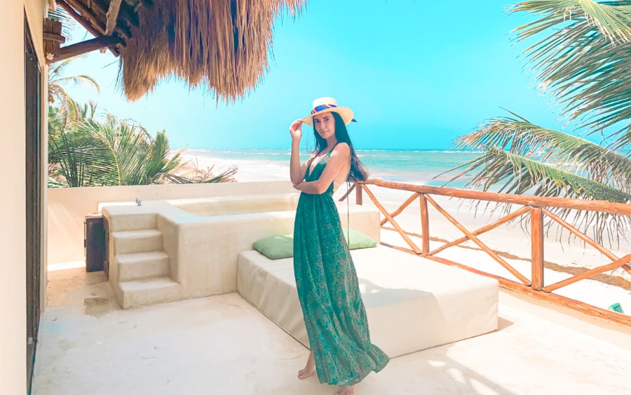 Clara standing on the terrace of the Dune hotel, with a private plunge pool and the beach in the background