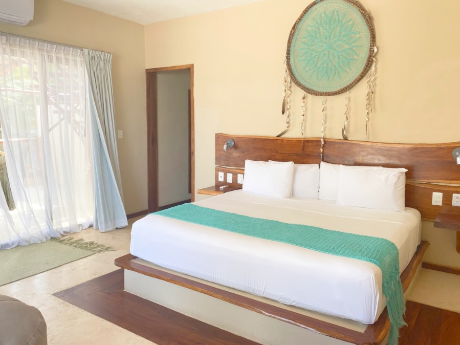 View of a bed at the Dune hotel rooms