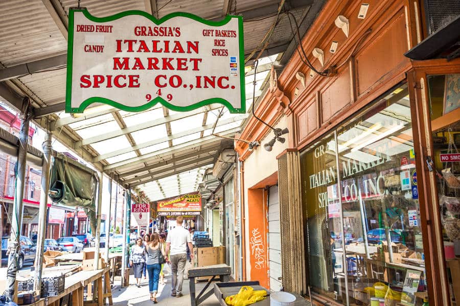 People strolling on the sidewalk of Italian Market in Philadelphia