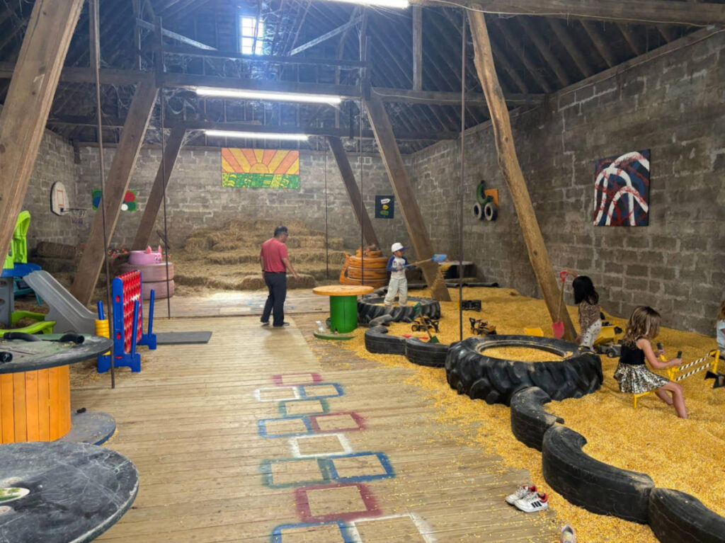 The kids at the children’s play area inside the barn in Echo Fields