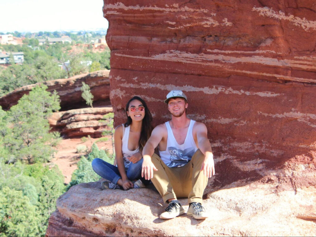 Travel Lemming editor Abigail and her husband sitting on a rock at the Garden of the Gods