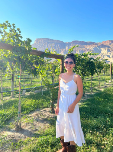 Editor Abigail in Palisade backdropped by the Book Cliffs