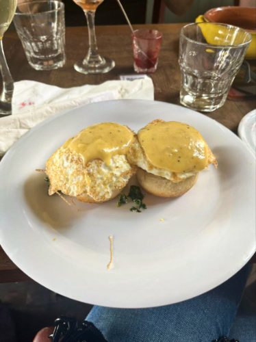 Two eggs florentine on a white plate from Cafe Triskell