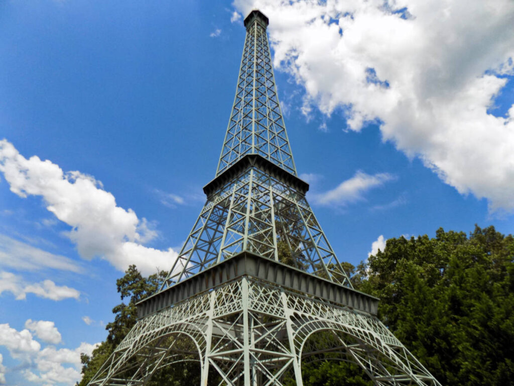 A replica of the Eiffel Tower with a clear blue sky in the background