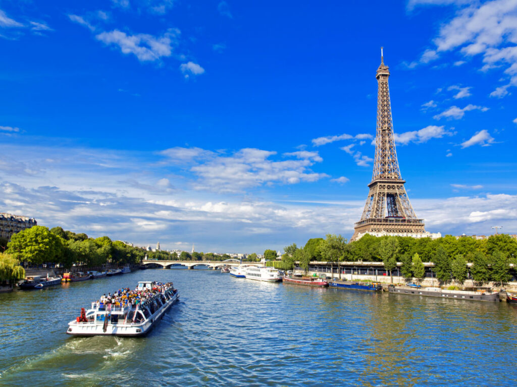 Boat cruising on Seine River with Eiffel Tower in background