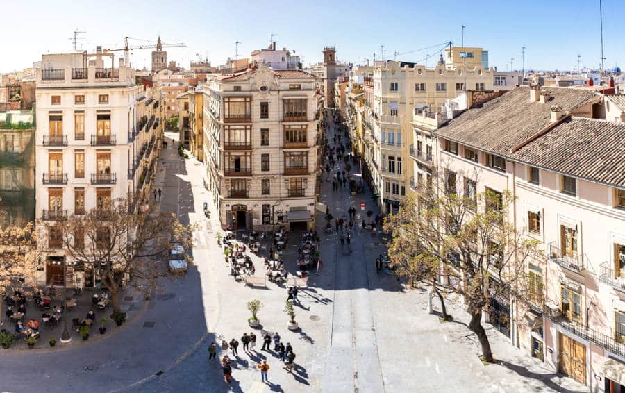 Aerial view of the great architectural infrastructures and people crossing in the street of the El Carmen neighborhood