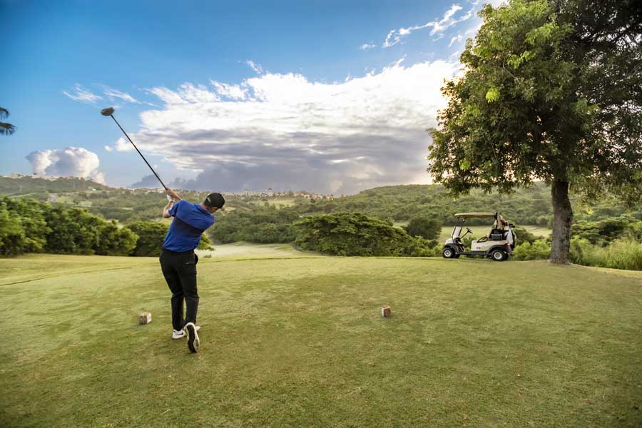 A man playing golf at the golf course of El Conquistador Resort