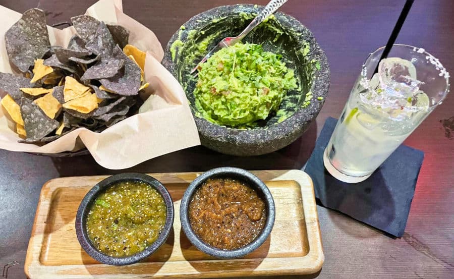 Famous guacamole and chips with a glass of Cadillac margarita from El Dorado Cantina