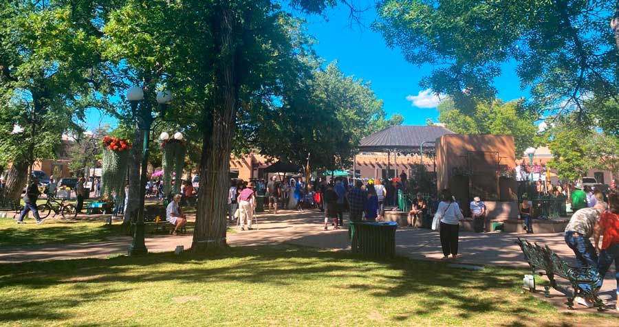 People enjoying their day during a sunny morning in Sante Fe Plaza Park