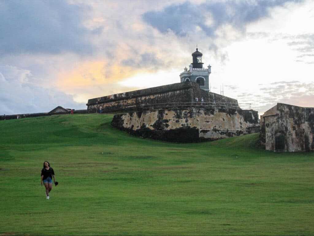 The author, Vanessa Ramos smiling for a photo at El Morro in Old San Juan