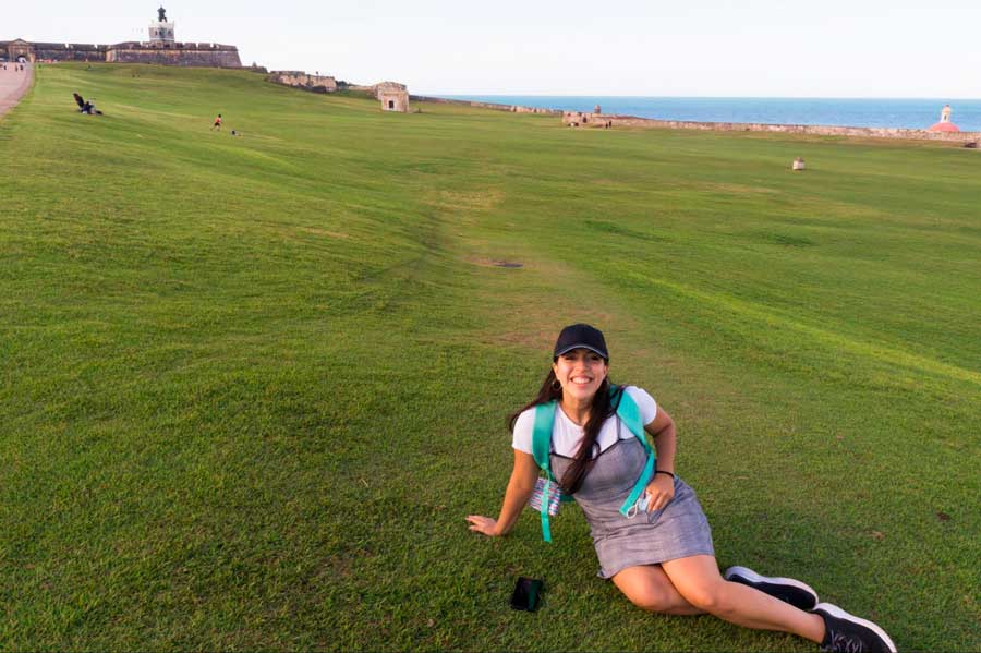 The author sitting on the grass in El Morro in Old San Juan