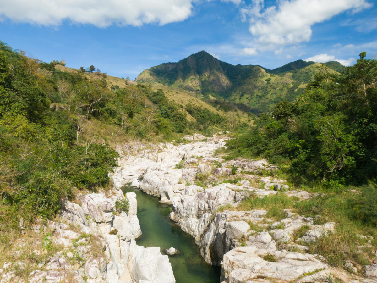 Aerial view of El sofá, a river with white rocks between mountains in Cañón Blanco