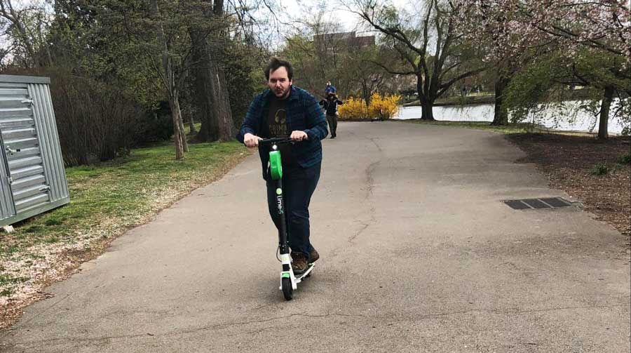 The author's husband on a electric scooter in Centennial Park