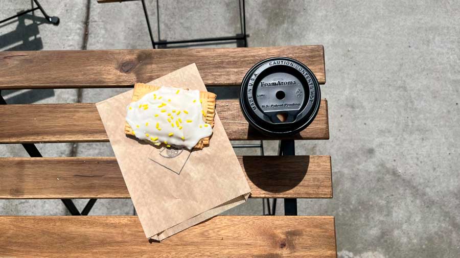 A pastry and a cup of coffee on a table in Elegy Coffee