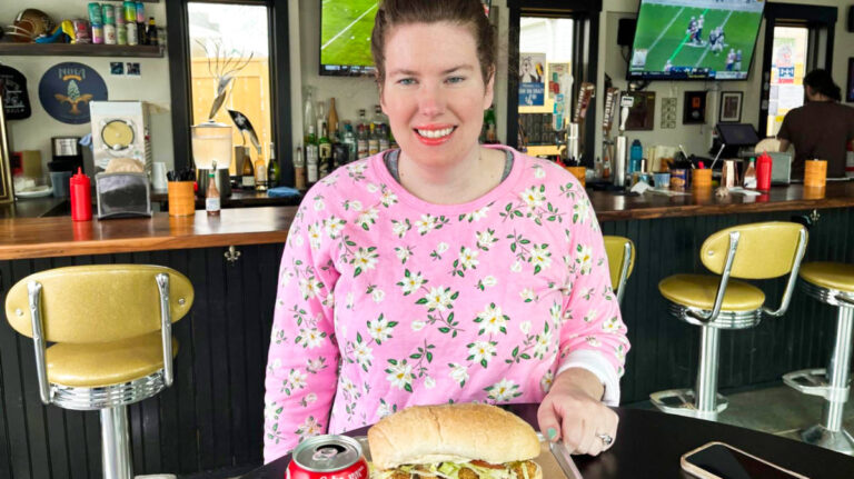 The author, Elizabeth Demolat posing with her food inside a restaurant